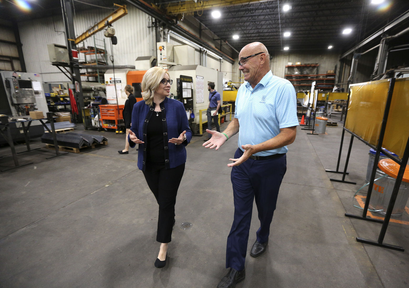 U.S. Rep. Ashley Hinson, R-Iowa, talks with Charlie Giese, president of Giese Companies in Dubuque during a tour of the manufacturing facility on Monday, May 23, 2022.    PHOTO CREDIT: Dave Kettering