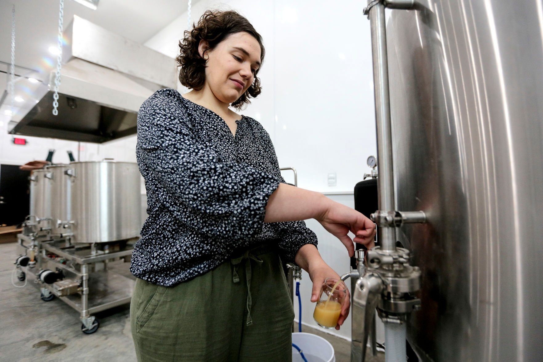 Kathryn Klaes who owns and operates Guttenberg (Iowa) Brewing Co., which soon will open, collects a sample beer to be tested on Wednesday, May 25, 2022.    PHOTO CREDIT: Dave Kettering