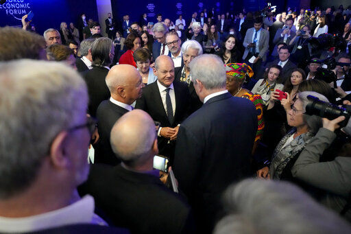 German chancellor Olaf Scholz, center, is surrounded by people at the World Economic Forum in Davos, Switzerland, Thursday, May 26, 2022. The annual meeting of the World Economic Forum is taking place in Davos from May 22 until May 26, 2022. (AP Photo/Markus Schreiber)    PHOTO CREDIT: Markus Schreiber