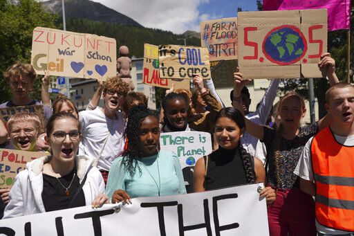 Climate activists Elizabeth Wathuti of Kenia, Vanessa Nakate of Uganda and Helena Gualinga of Ecuador attend the climate protest alongside the World Economic Forum in Davos, Switzerland, Thursday, May 26, 2022. The annual meeting of the World Economic Forum is taking place in Davos from May 22 until May 26, 2022. (AP Photo/Evgeniy Maloletka)    PHOTO CREDIT: Evgeniy Maloletka