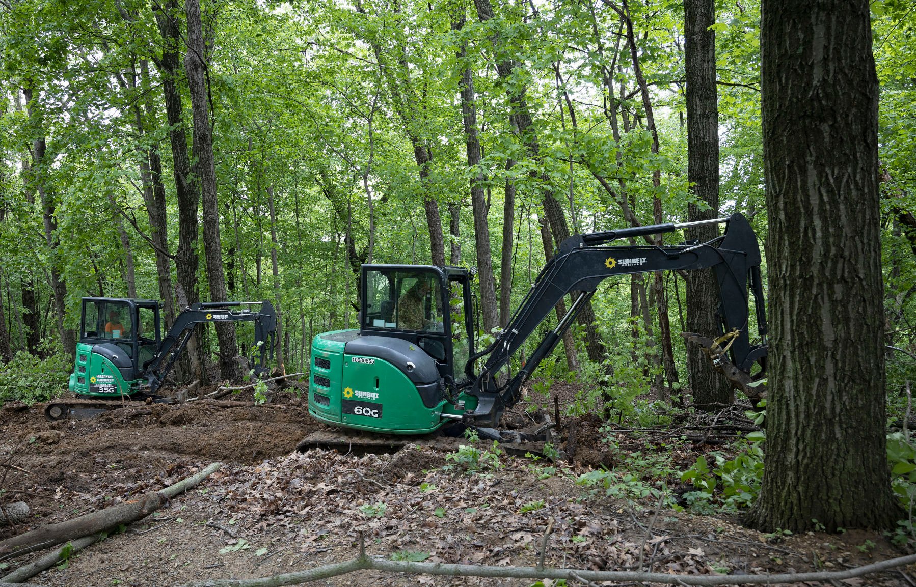 Employees with Pathfinder Trail Building, of Eagan, Minn., work on a new mountain bike trail at Chestnut Mountain Resort in Galena, Ill., on Friday.    PHOTO CREDIT: Stephen Gassman