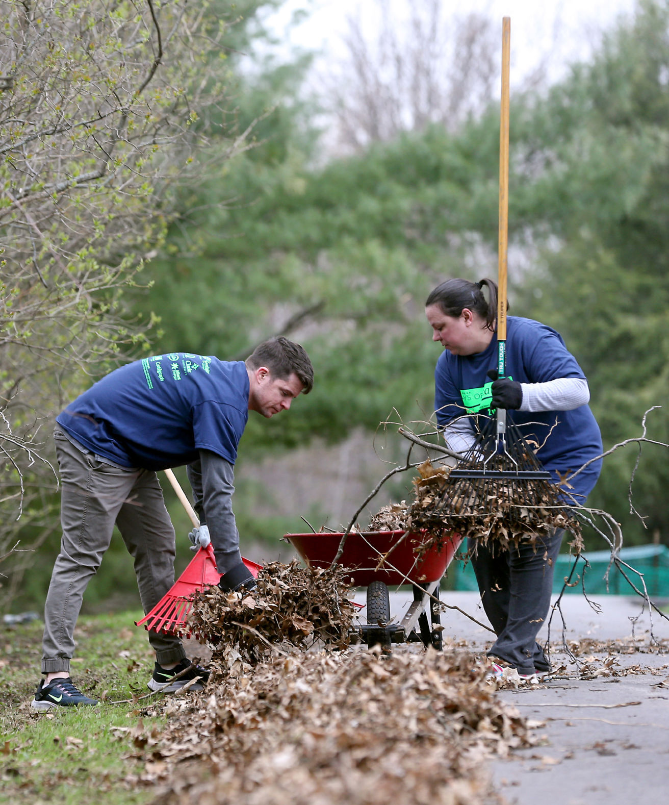 Brandon Lynch (left) and Sara Waldron, employees of Dubuque Bank & Trust, clear debris.    PHOTO CREDIT: JESSICA REILLY