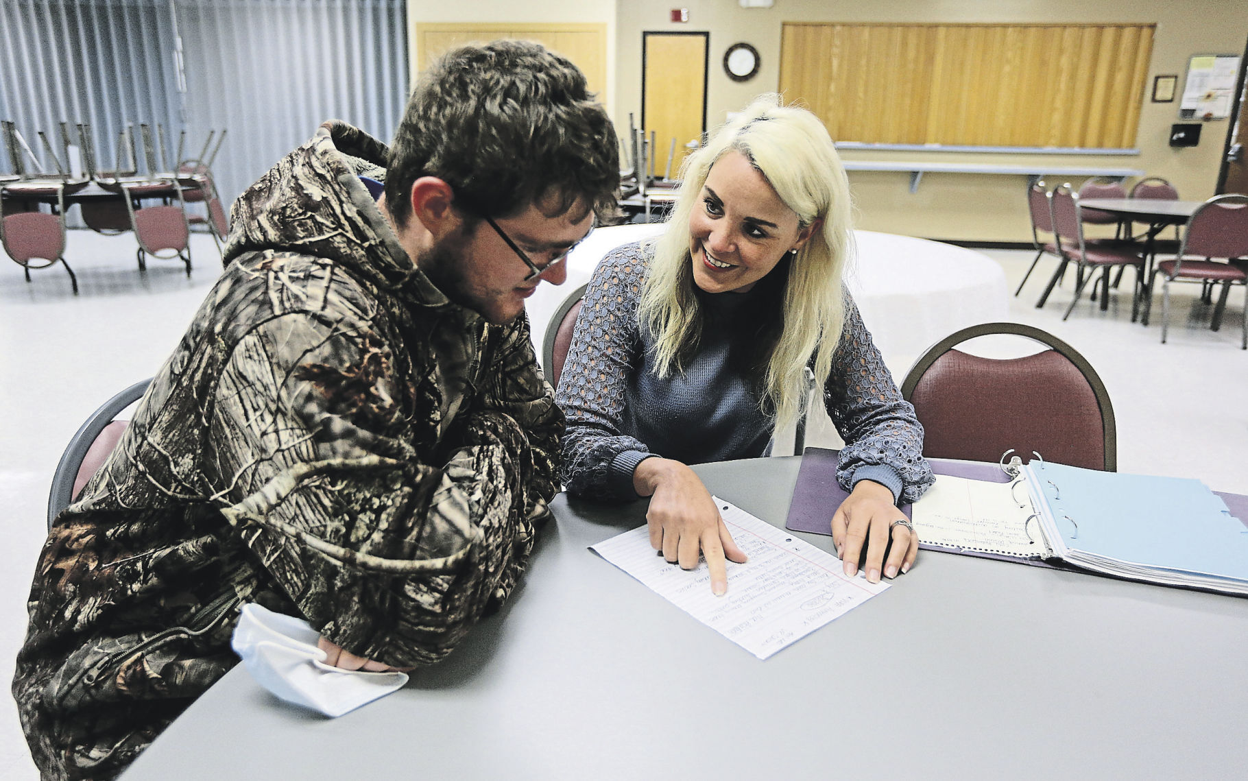 Kara Huss, Community Services Director at Hills & Dales in Dubuque, works with client, Cody Robinson, at the Hills & Dales Community Center.    PHOTO CREDIT: Dave Kettering