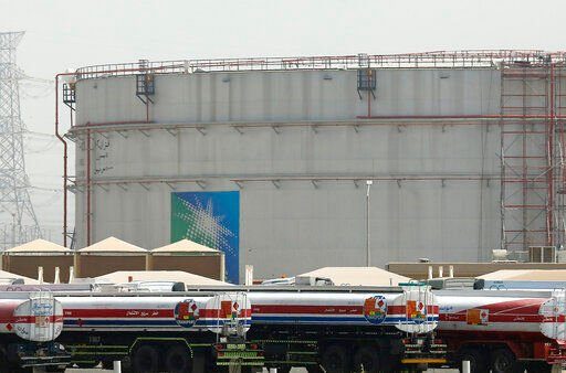 FILE - Fuel trucks line up in front of storage tanks at the North Jiddah bulk plant, an Aramco oil facility, in Jiddah, Saudi Arabia, on March 21, 2021. The OPEC oil cartel and allied countries including major exporter Russia are weighing how much oil to send to the world economy as U.S. gas prices hit another record high.  Thursday’s meeting comes amid speculation that the 23-member alliance, known as OPEC+, may considered breaking from its cautious series of increases and agree to pump more oil amid fears that high energy prices could slow the global economy. (AP Photo/Amr Nabil, File)    PHOTO CREDIT: Amr Nabil