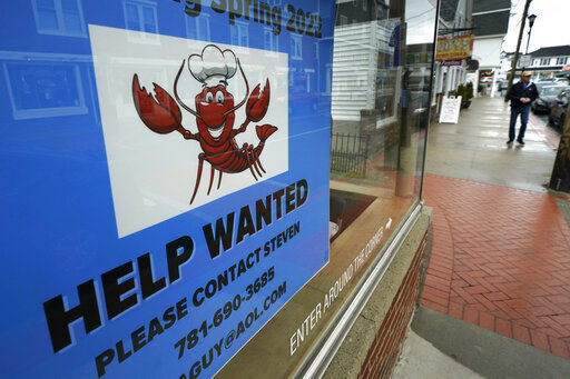 A sign advertises for help at a restaurant Wednesday, June 1, 2022, in York Beach, Maine. Many summer businesses are struggling to find enough workers before the busy tourism season. (AP Photo/Robert F. Bukaty)    PHOTO CREDIT: Robert F. Bukaty