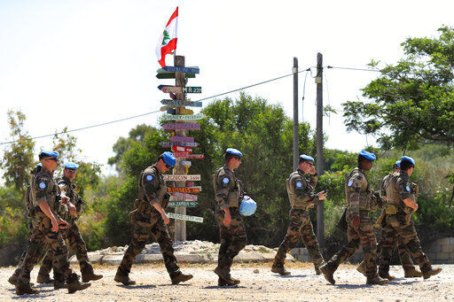 French U.N. peacekeepers walk on a road that leads to a United Nations Interim Force In Lebanon position, in the southern coastal border Lebanese-Israeli town of Naqoura, Lebanon, Monday, June 6, 2022. The Lebanese government invited on Monday a U.S. envoy mediating between Lebanon and Israel over their disputed maritime border to return to Beirut as soon as possible to work out an agreement amid rising tensions along the border. (AP Photo/Mohammed Zaatari)    PHOTO CREDIT: Mohammad Zaatari