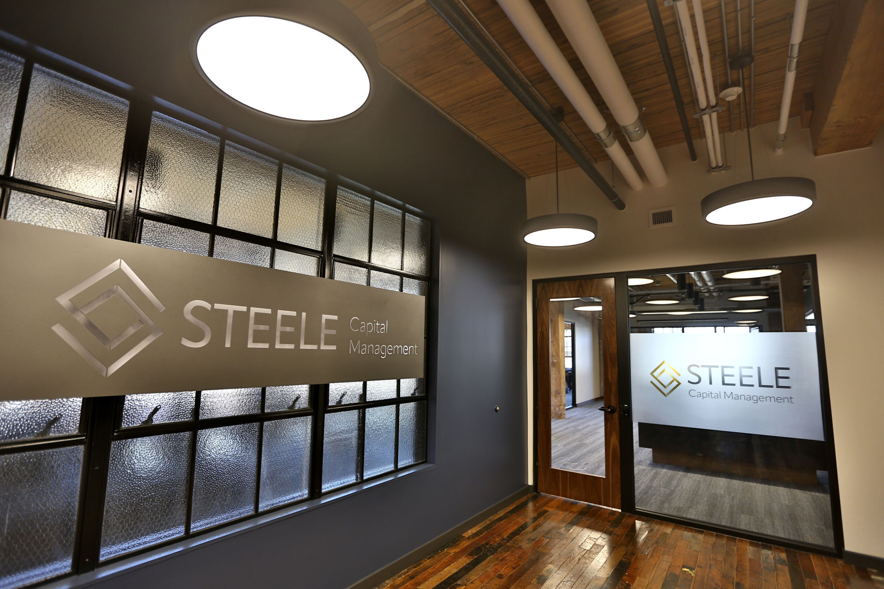 A view of the entrance to Steele Capital Management in its new space in the Dupaco Voices Building at 1000 Jackson St.. on Thursday, June 2, 2022.    PHOTO CREDIT: Dave Kettering