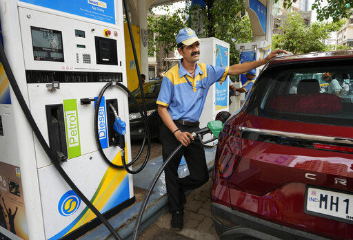 An employee of a Bharat petroleum fuel station fills petrol in a vehicle in Mumbai, India. India and other Asian nations are becoming an increasingly vital source of oil revenues for Moscow as the U.S. and other Western countries cut their energy imports from Russia in line with sanctions over its war on Ukraine.    PHOTO CREDIT: Rajanish Kakade