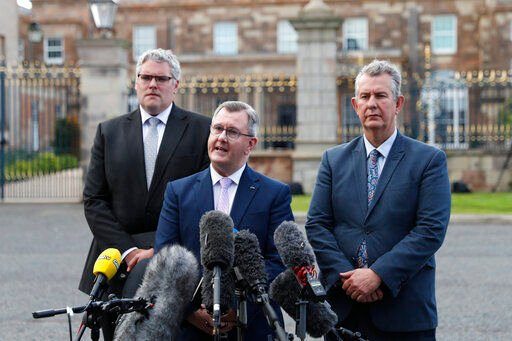 FILE - Democratic Unionist Party leader Jeffrey Donaldson, centre, and party colleagues Gavin Robinson left, and Edwin Poots talk to the media at Hillsborough Castle, Northern Ireland, Monday, May, 16, 2022. Britain’s government is expected to introduce legislation that would unilaterally change post-Brexit trade rules for Northern Ireland amid opposition from lawmakers who believe the move violates international law. The legislation, expected Monday, June 13, 2022, would let the government bypass the so-called Northern Ireland Protocol, which requires the inspection of some goods shipped there from other parts of the United Kingdom. (AP Photo/Peter Morrison, File)    PHOTO CREDIT: Peter Morrison