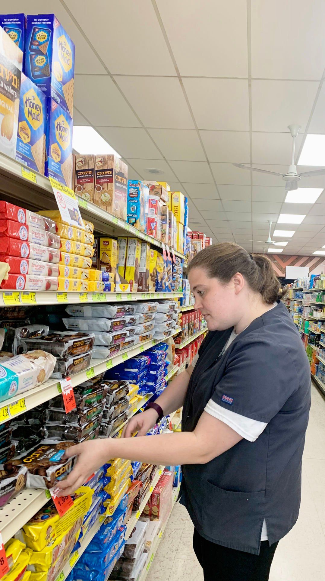 Kelicia Kelley, an employee at Okey’s Market, Cassville, Wis., straightens items on a shelf at the store. The store was established in 1933 in the Grant County community.    PHOTO CREDIT: Erik Hogstrom