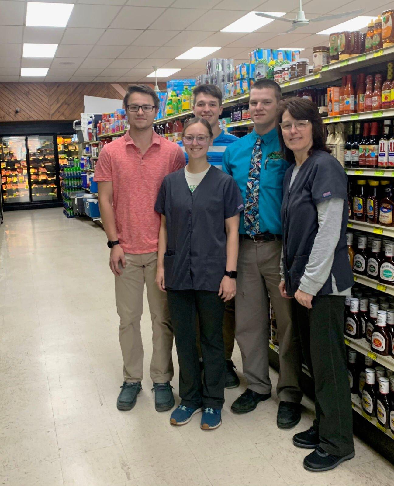Okey family members Ezra (from left), Andrea (Okey) Gille, Erasmus, Elijah and Patty pose at the Cassville, Wis., grocery store that was founded by Walter Okey in 1933.    PHOTO CREDIT: Erik Hogstrom