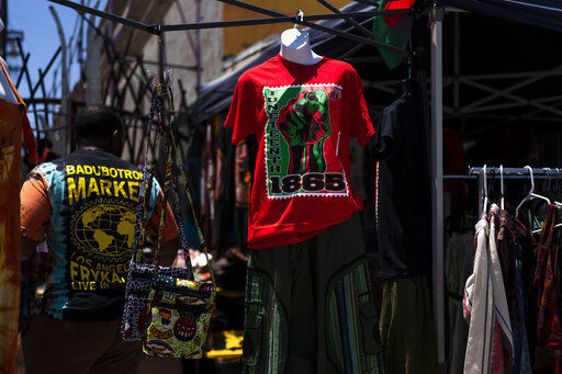A Juneteenth T-shirt is for sale in Los Angeles, Friday, June 17, 2022. Retailers and marketers from Walmart to Amazon have been quick to commemorate Juneteenth with an avalanche of merchandise from ice cream to T-shirts to party favors. (AP Photo/Jae C. Hong)    PHOTO CREDIT: Jae C. Hong