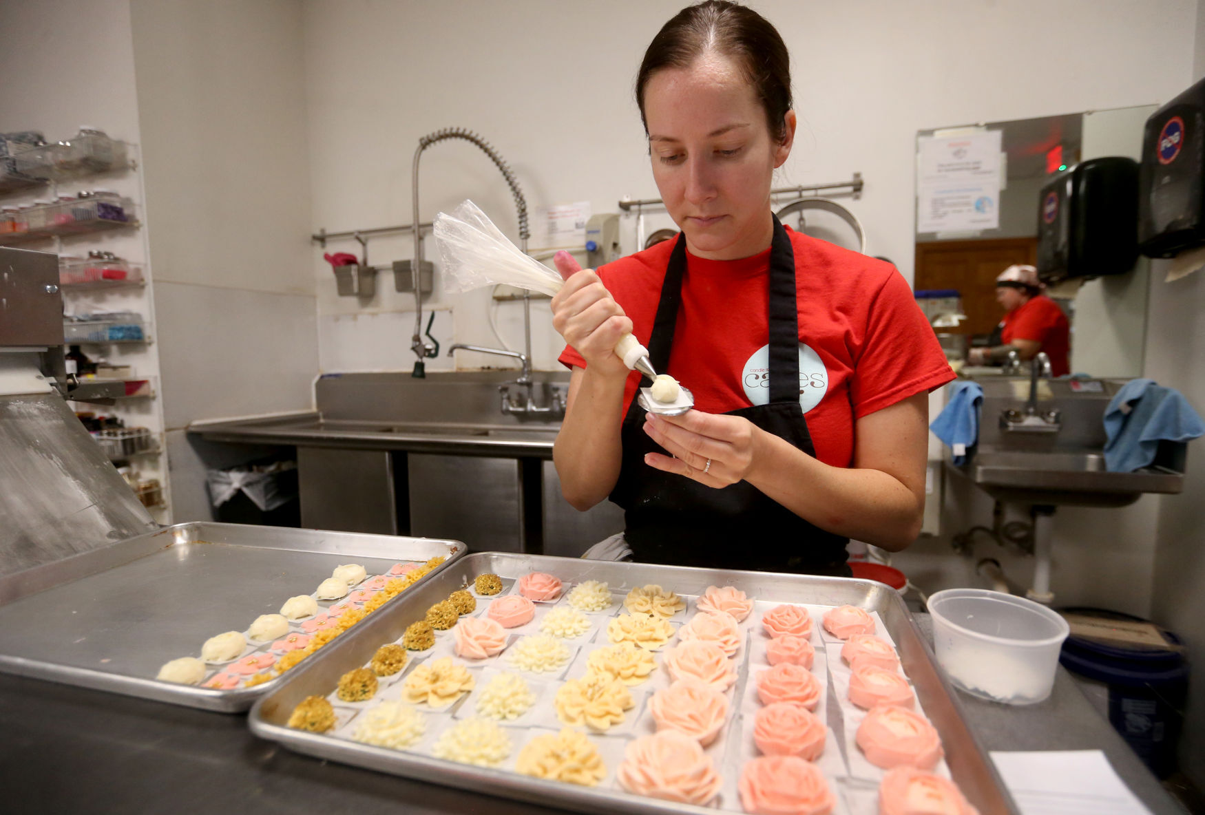 Jill Takosky prepares items at Candle Ready Cakes in Dubuque on Thursday, June 23, 2022. The store plans to move to a new, larger location at 249 W. First St. in Dubuque.    PHOTO CREDIT: JESSICA REILLY