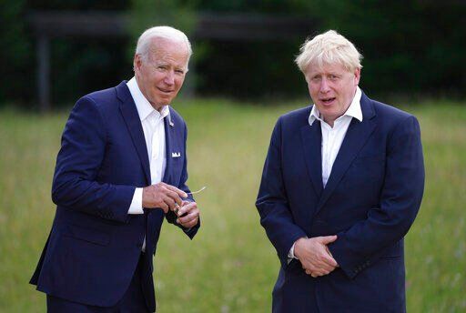 U.S. President Joe Biden, left, speaks with British Prime Minister Boris Johnson during the official G7 group photo at Castle Elmau in Kruen, near Garmisch-Partenkirchen, Germany, on Sunday, June 26, 2022. The Group of Seven leading economic powers are meeting in Germany for their annual gathering Sunday through Tuesday. (AP Photo/Matthias Schrader)    PHOTO CREDIT: Matthias Schrader