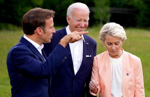 From left, French President Emmanuel Macron, U.S. President Joe Biden and European Commission President Ursula von der Leyen after the official G7 group photo at Castle Elmau in Kruen, near Garmisch-Partenkirchen, Germany, on Sunday, June 26, 2022. The Group of Seven leading economic powers are meeting in Germany for their annual gathering Sunday through Tuesday. (AP Photo/Matthias Schrader)    PHOTO CREDIT: Matthias Schrader