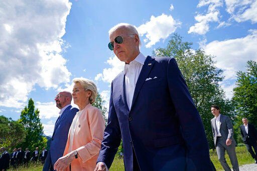 President Joe Biden, right, walks with European Commission President Ursula von der Leyen, center, and European Council President Charles Michel, left, as they head to a family photo with the G7 leaders at the G7 Summit in Elmau, Germany, Sunday, June 26, 2022. (AP Photo/Susan Walsh, Pool)    PHOTO CREDIT: Susan Walsh