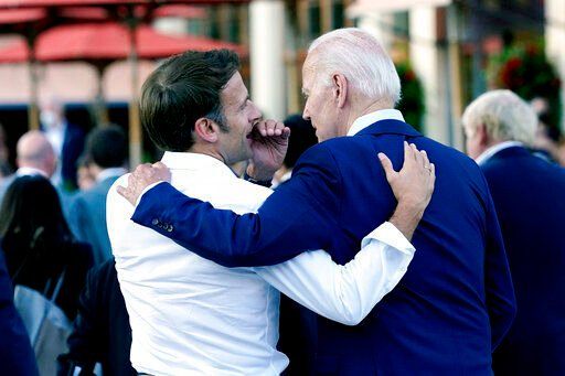 French President Emmanuel Macron whispers to U.S. President Joe Biden following their dinner at the G7 Summit in Elmau, Germany, Sunday, June 26, 2022. (AP Photo/Susan Walsh)    PHOTO CREDIT: Susan Walsh