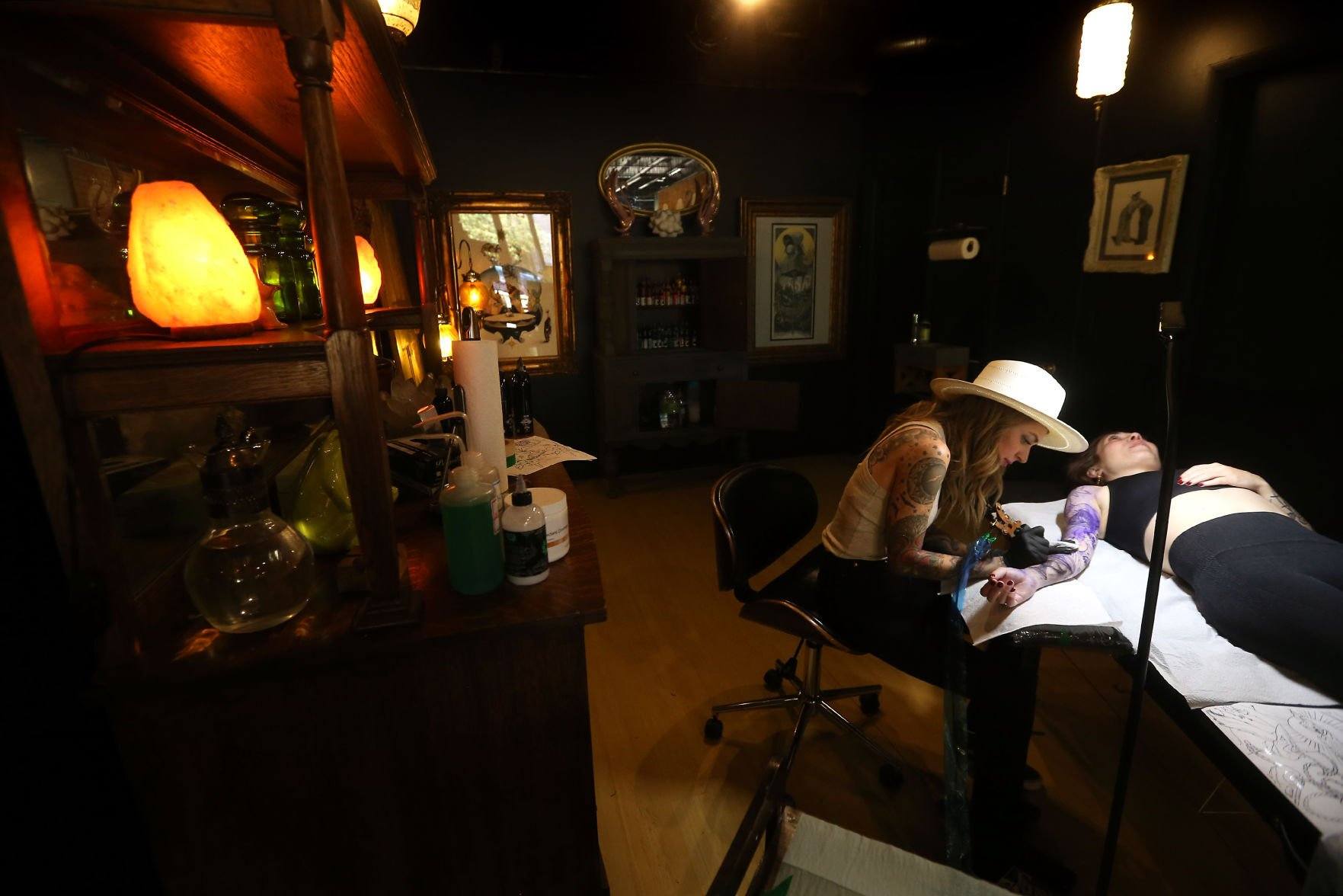 Owner Sarah Anderson tattoos Chelsey Shone, of Fayetteville, Ark., at Goldies in Dubuque on Friday, June 24, 2022. Anderson recently opened the tattoo studio at 251 W. Eighth St.    PHOTO CREDIT: JESSICA REILLY