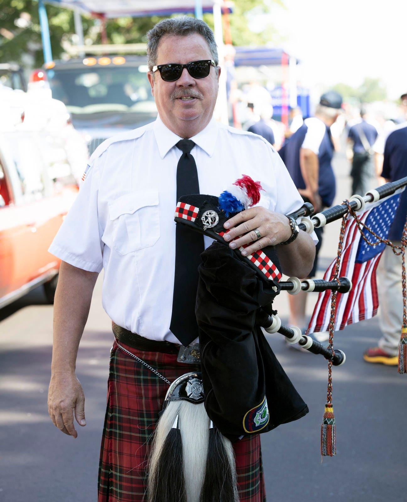 Bill Spivey plays with Dubuque Fire Pipes & Drums as they march in the parade during Heritage Days in Bellevue, Iowa.    PHOTO CREDIT: Stephen Gassman