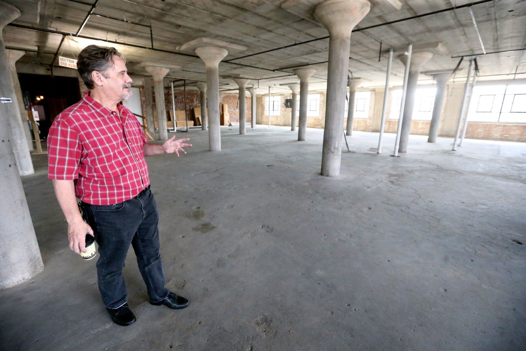 Bob Johnson, co-owner of the Novelty Iron Works building in the Millwork District, shows the location where a new boutique hotel will be constructed.    PHOTO CREDIT: JESSICA REILLY