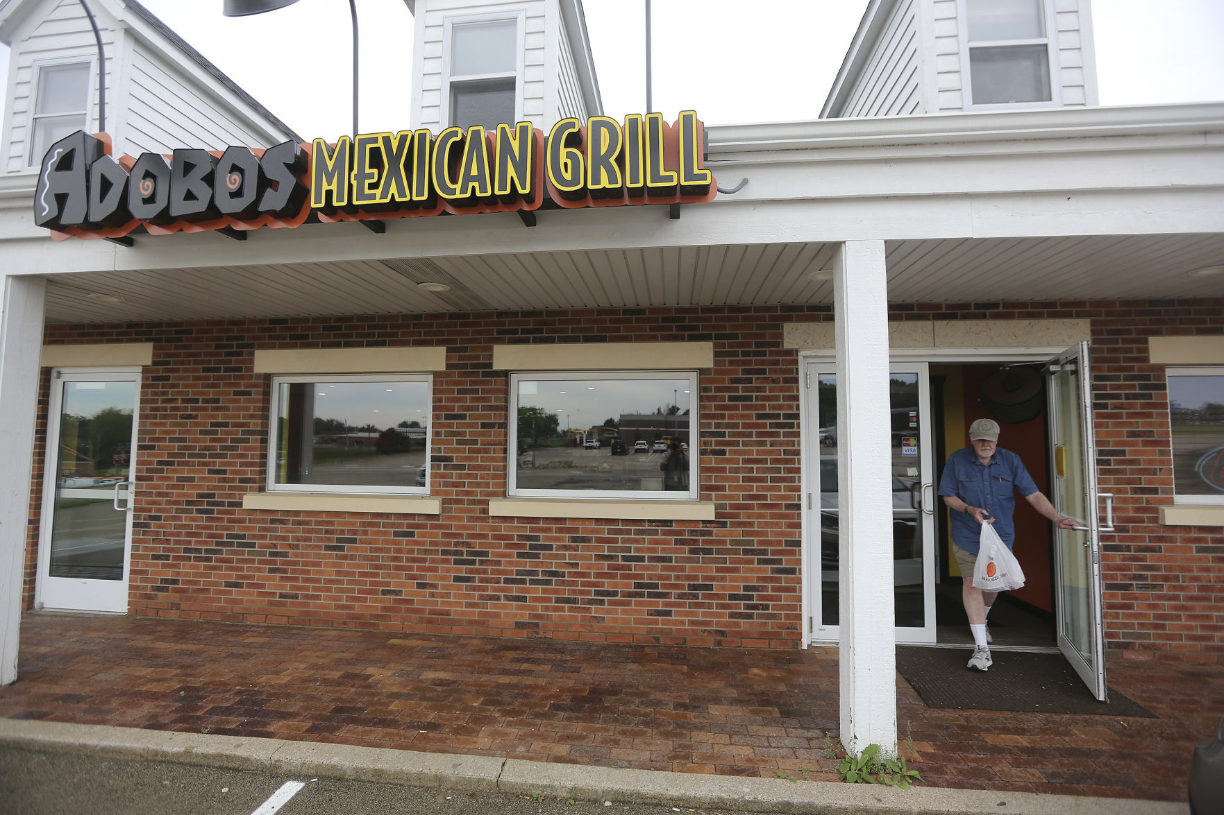 A customer exits Adobos Mexican Grill in Galena, Ill. recently.    PHOTO CREDIT: Dave Kettering