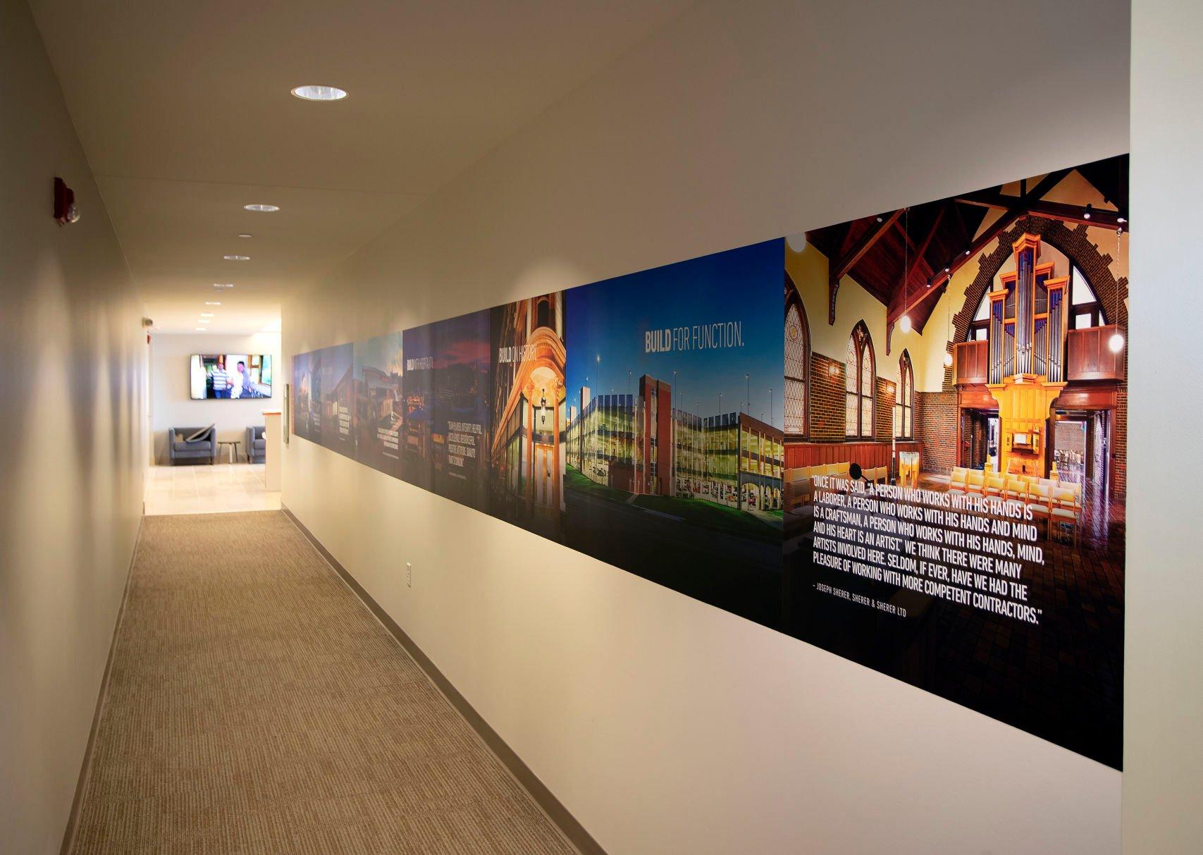 A hallway showcasing some past projects at Conlon Construction’s new corporate offices in Dubuque. The company began in 1903 in Cuba City, Wis. It moved to Dubuque in 1922 and has continued family ownership the entire time.    PHOTO CREDIT: Stephen Gassman