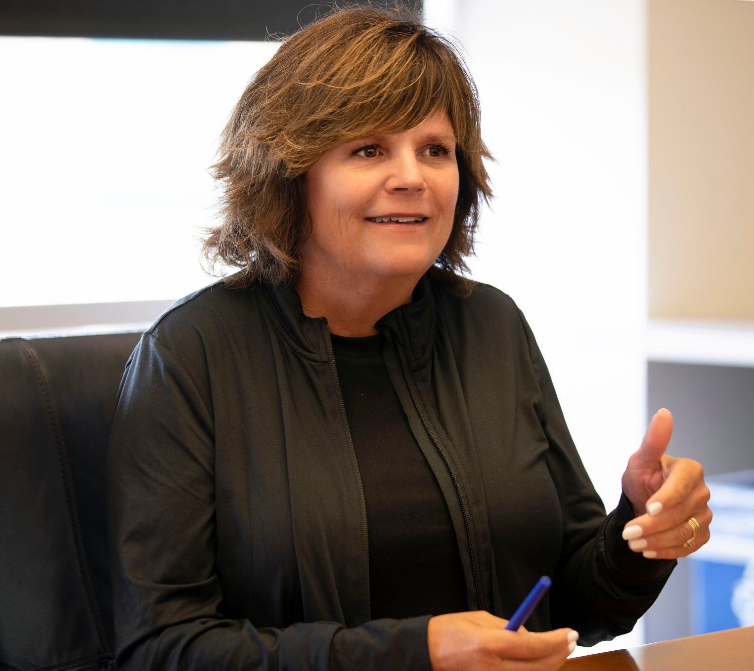 Becky Conlon, vice president and director of market and owner engagement sits in a conference room at Conlon Construction’s new corporate offices in Dubuque.    PHOTO CREDIT: Stephen Gassman