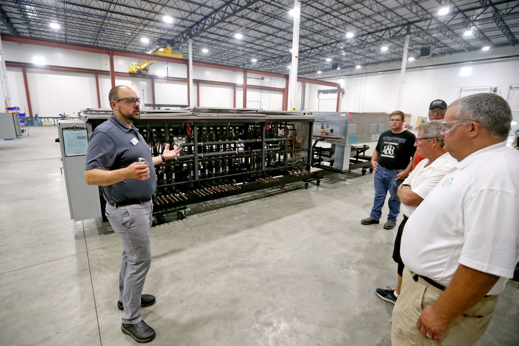Ben Fisher (left) gives a tour of Zero Zone during an event at the facility in Dyersville, Iowa, on Wednesday, July 20, 2022.    PHOTO CREDIT: JESSICA REILLY
