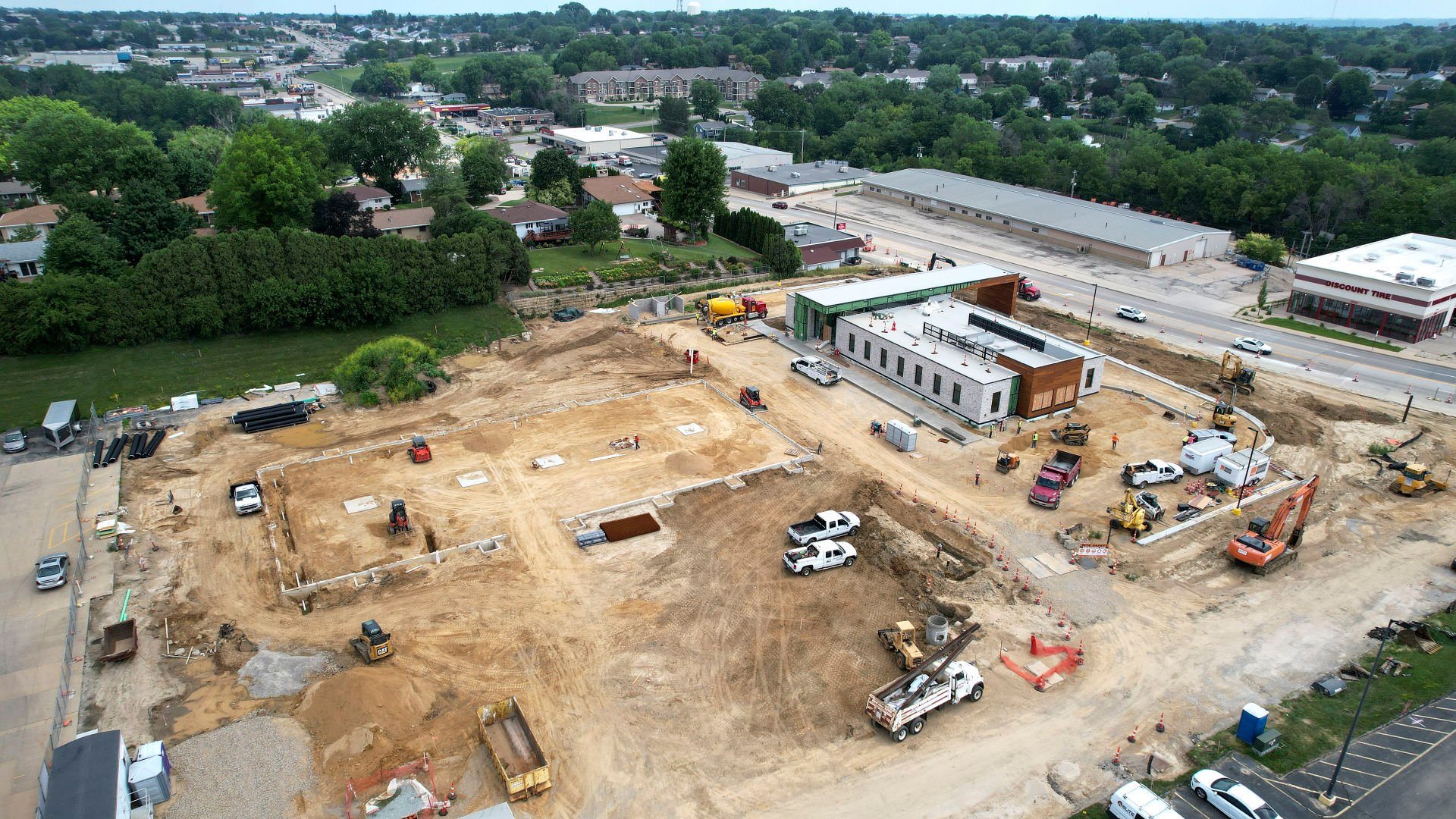 Work continues on constructing an 11,400-square-foot retail building (left) on Stoneman Road, near the new Green State Credit Union on Wednesday, July 20, 2022.    PHOTO CREDIT: Dave Kettering