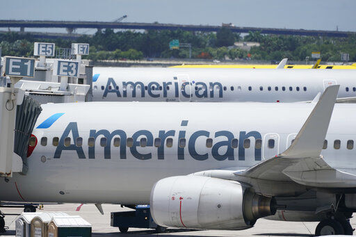 American Airlines says it earned $476 million in the second quarter as summer travelers packed planes. It was American