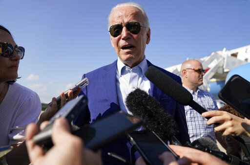 President Joe Biden speaks to members of the media after exiting Air Force One on Wednesday at Andrews Air Force Base, Md. Biden has tested positive for COVID-19 today.    PHOTO CREDIT: Evan Vucci