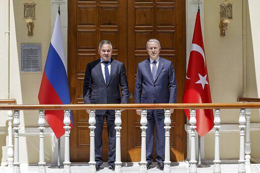 In this handout photo released by Russian Defense Ministry Press Service, Russian Defense Minister Sergei Shoigu, left, and Turkish Defense Minister Hulusi Akar pose for a photo during their meeting in Istanbul, Turkey, Friday, July 22, 2022. U.N. Secretary General Antonio Guterres and Turkish President Recep Tayyip Erdogan were due on Friday to oversee the signing of a key agreement that would allow Ukraine to resume its shipment of grain from the Black Sea to world markets and for Russia to export grain and fertilizers, ending a standoff that has threatened world food security. (Vadim Savitsky, Russian Defense Ministry Press Service via AP)    PHOTO CREDIT: Vadim Savitsky