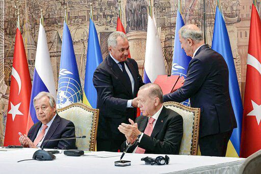 In this handout photo released by Russian Defense Ministry Press Service, Turkish President Recep Tayyip Erdogan, right, and U.N. Secretary General, Antonio Guterres, sit as Russian Defense Minister Sergei Shoigu, top left, and Turkish Defense Minister Hulusi Akar, top right, exchange documents during a signing ceremony at Dolmabahce Palace in Istanbul, Turkey, Friday, July 22, 2022. U.N. Secretary General Antonio Guterres and Turkish President Recep Tayyip Erdogan were due on Friday to oversee the signing of a key agreement that would allow Ukraine to resume its shipment of grain from the Black Sea to world markets and for Russia to export grain and fertilizers, ending a standoff that has threatened world food security. (Vadim Savitsky, Russian Defense Ministry Press Service via AP)    PHOTO CREDIT: Vadim Savitsky