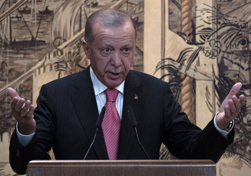 Turkish President Recep Tayyip Erdogan delivers a speach during a signing ceremony at Dolmabahce Palace in Istanbul, Turkey, Friday, July 22, 2022. U.N. Secretary General Antonio Guterres and Turkish President Recep Tayyip Erdogan were due on Friday to oversee the signing of a key agreement that would allow Ukraine to resume its shipment of grain from the Black Sea to world markets and for Russia to export grain and fertilizers, ending a standoff that has threatened world food security. (AP Photo/Khalil Hamra)    PHOTO CREDIT: Khalil Hamra