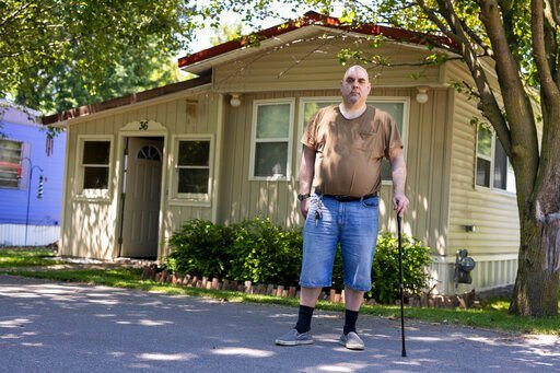 Jeremy Ward poses for a portrait in front of his home in the Ridgeview Homes mobile home community in Lockport, N.Y. Ward is one of the residents at Ridgeview participating in a rent strike after new owners of the park announced they were raising rents by 6%.    PHOTO CREDIT: Lauren Petracca
