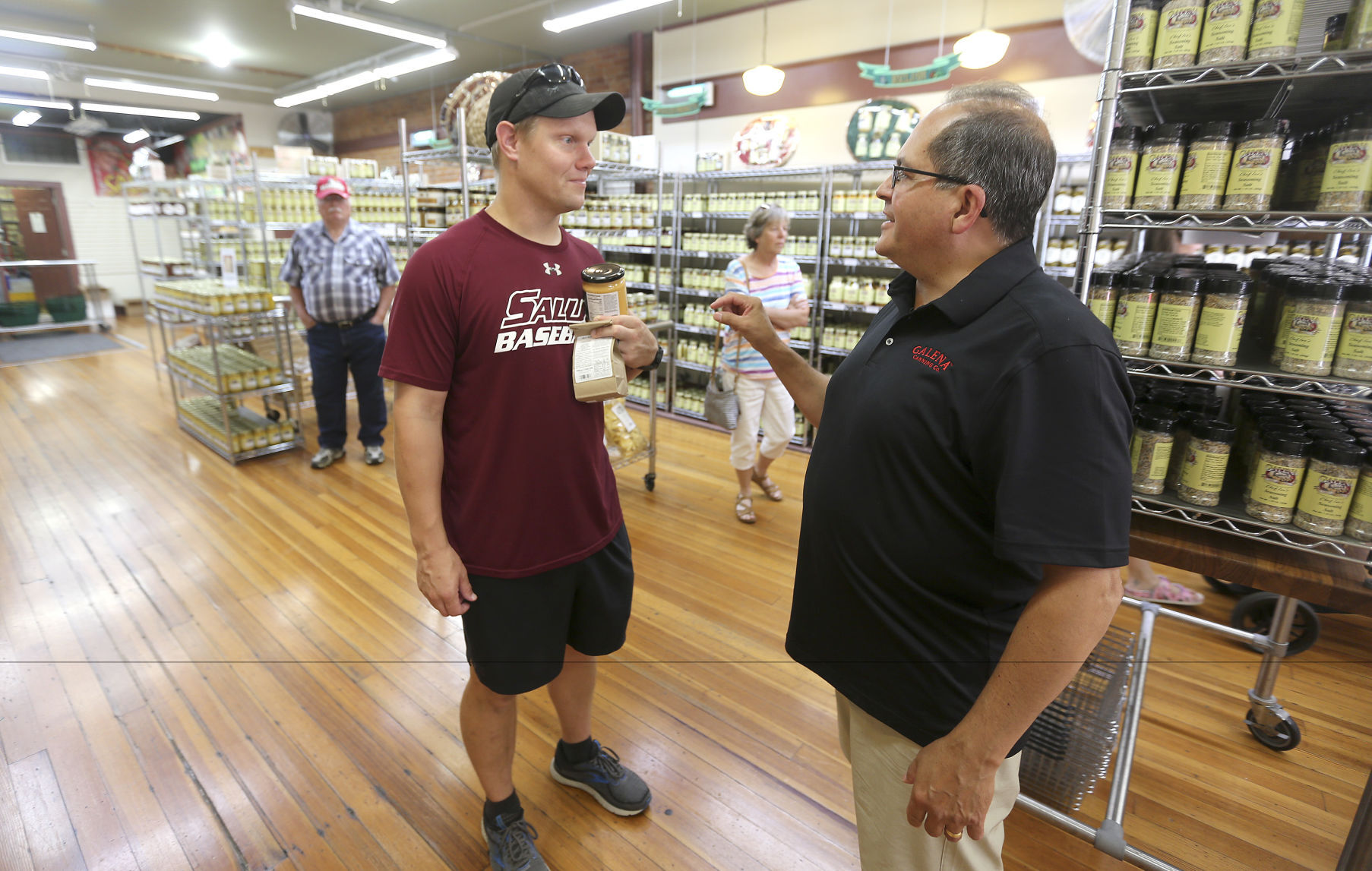 Tim Kelly (left) talks with Jeff Holder, co-owner of the Galena Canning Co., on Thursday, July 21, 2022.    PHOTO CREDIT: Dave Kettering