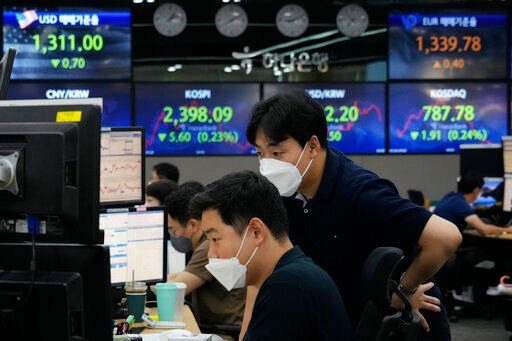 Currency traders watch monitors at the foreign exchange dealing room of the KEB Hana Bank headquarters in Seoul, South Korea, Tuesday, July 26, 2022. Asian stock markets were mostly higher Tuesday as investors braced for another sharp interest rate hike by the Federal Reserve to cool inflation. (AP Photo/Ahn Young-joon)    PHOTO CREDIT: Ahn Young-joon