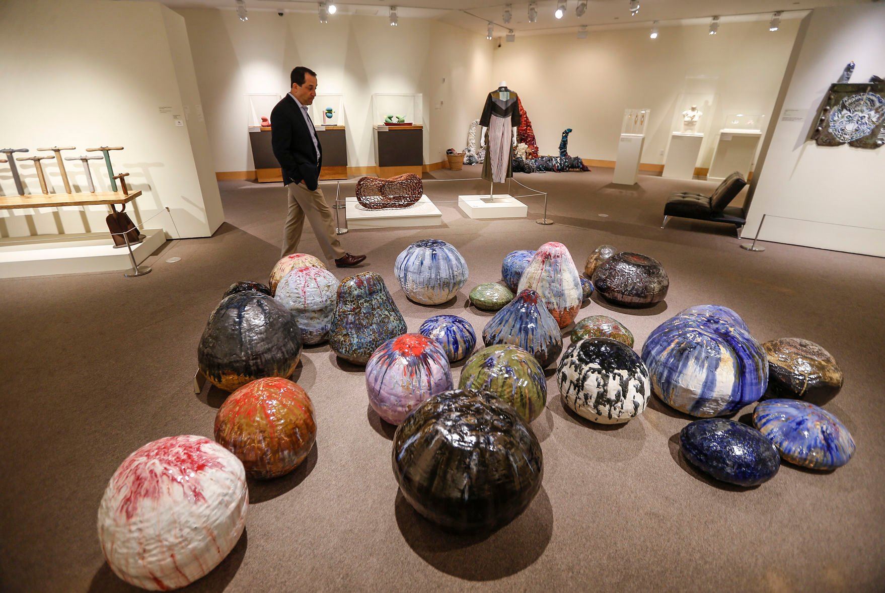 Executive Director Gary Stoppelman walks past an exhibit by William J. O’Brien, titled “Earth, Water, Fire, Wind, and Space Pt. 2,” at the Dubuque Museum of Art on Tuesday.    PHOTO CREDIT: Dave Kettering