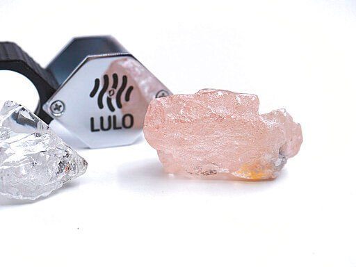 This photo supplied by Lucapa Diamond Company shows the 170 carat pink diamond, right, recovered from Lulo, Angola. A big pink diamond of 170 carats has been discovered in Angola and is claimed to be the largest such gemstone found in 300 years. Called the “Lulo Rose,” the diamond was found at the Lulo alluvial diamond mine. The mine’s owner, the Lucapa Diamond Company today announced the discovery of the large pink diamond on its website.    PHOTO CREDIT: HONS