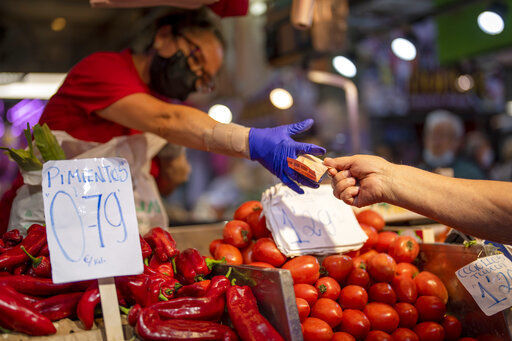 FILE - A customer pays for vegetables at the Maravillas market in Madrid, on May 12, 2022. Annual inflation in the eurozone’s 19 countries rose to 8.9% in July, from 8.6% in June, according to the latest numbers published Friday by the European Union statistics agency. (AP Photo/Manu Fernandez, File)    PHOTO CREDIT: Manu Fernandez