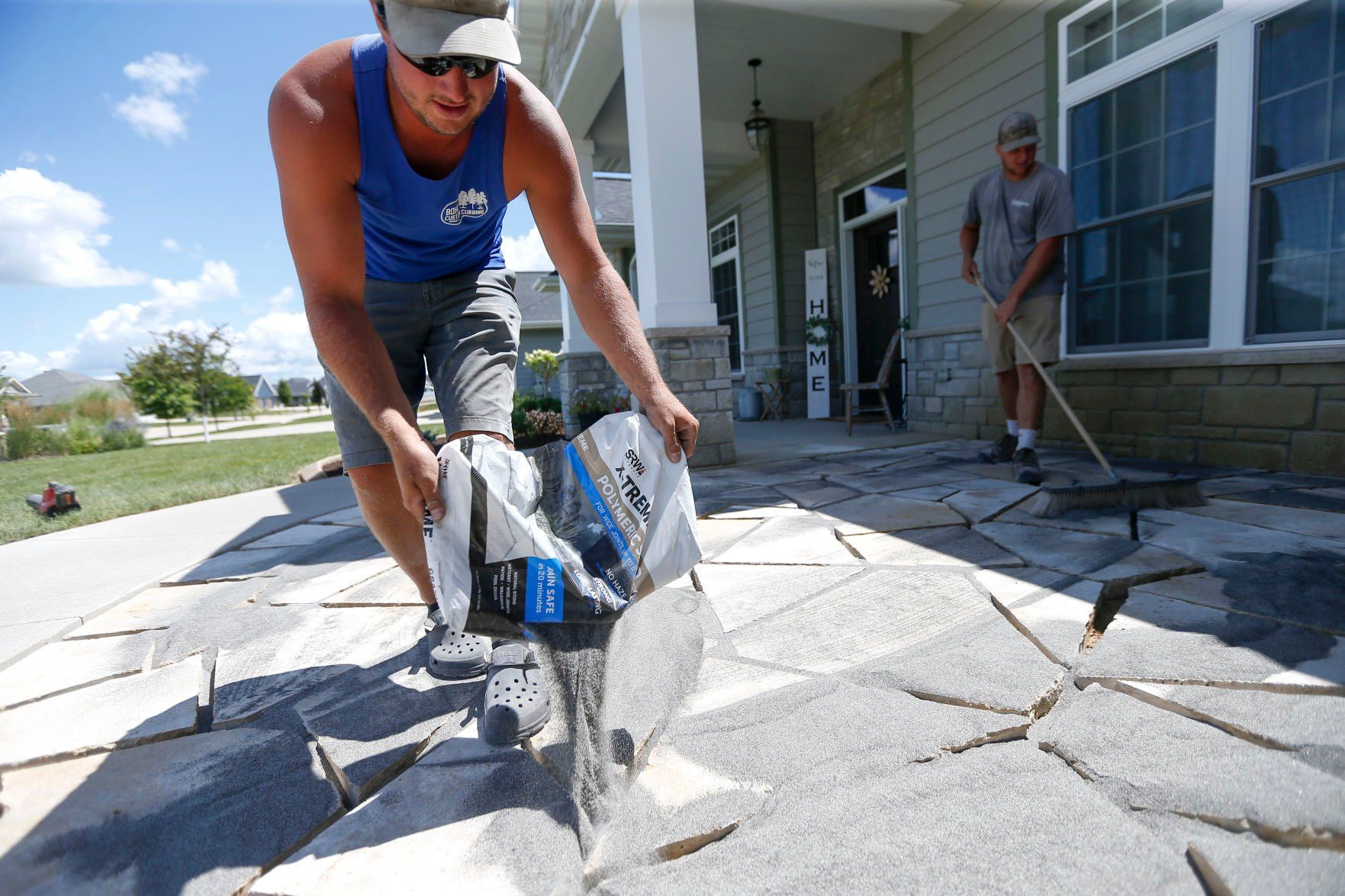 Jake Bohr, owner of Cornerstone Nursery in Dubuque, works on a landscaping project in Dubuque on Friday. Bohr opened his business earlier this year. “It’s hard, and there’s a lot of stress,” Bohr said. “But I’ve never really been good at having a lot of people tell me what to do, so I needed to be my own boss, and it’s been awesome.”    PHOTO CREDIT: Dave Kettering