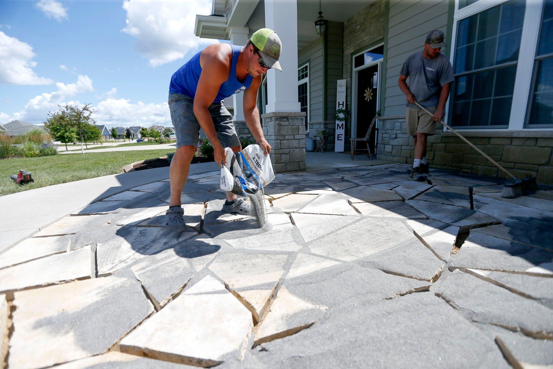 Jake Bohr owner of Cornerstone Nursery in Dubuque works on a landscaping project in Dubuque Friday, July 29, 2022. Bohr opened his business earlier this year.    PHOTO CREDIT: Dave Kettering