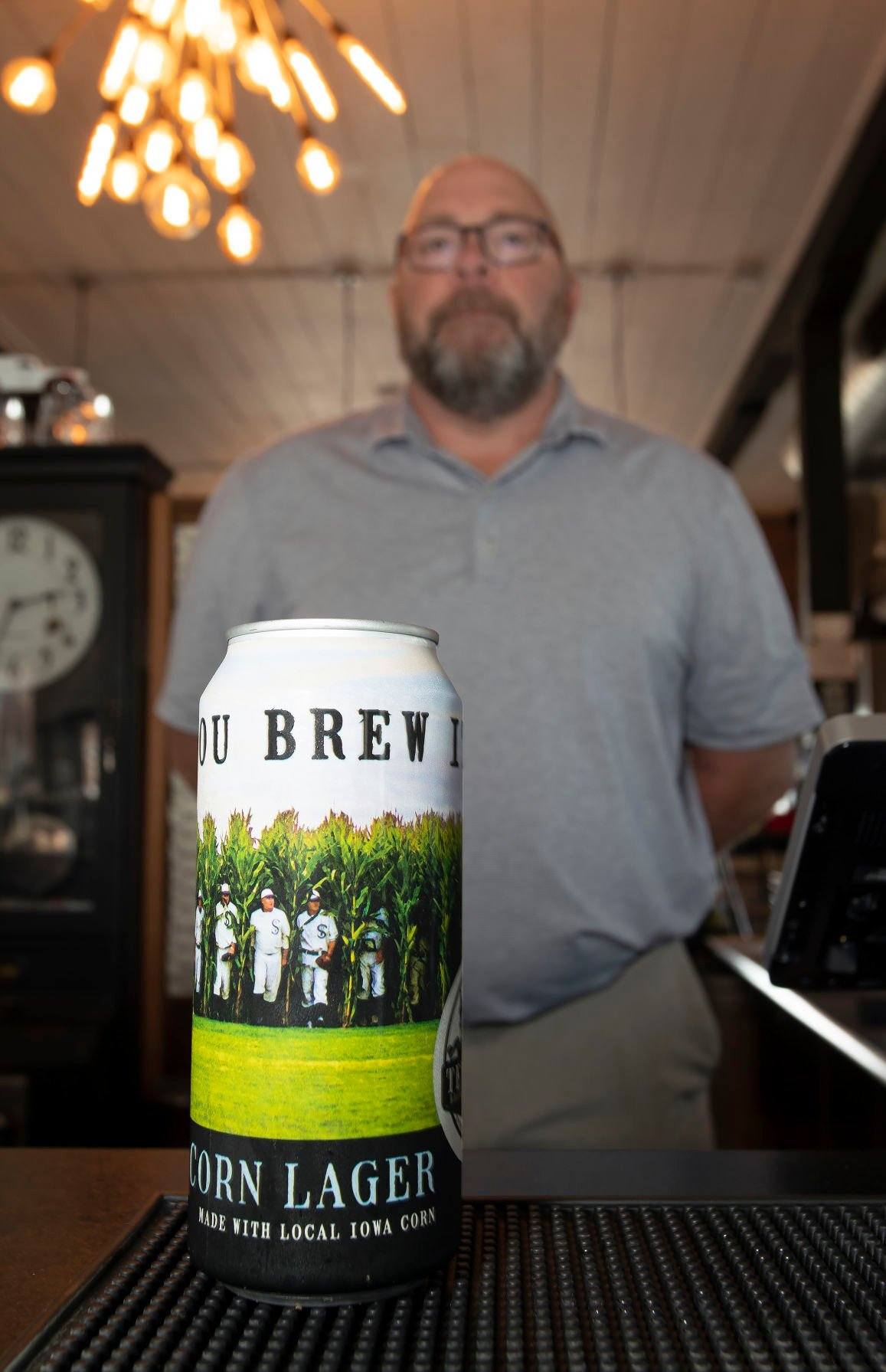 Textile Brewing Company owner Tom Olberding shows off a can of If You Brew It, Corn Lager, at the brewery in Dyersville, Iowa on Tuesday, August 2, 2022.    PHOTO CREDIT: Stephen Gassman