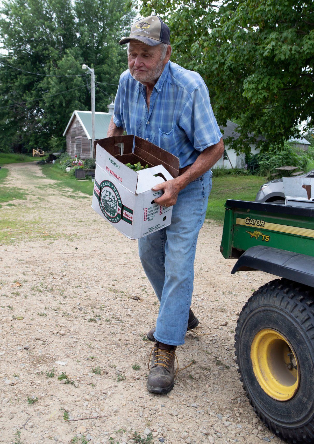 Vernon Kruse unloads a box of pickles on his family’s farm in rural Lancaster.    PHOTO CREDIT: Stephen Gassman