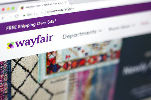 FILE- This April 17, 2018, file photo shows the Wayfair website on a computer in New York. Wayfair, on Friday, Aug. 19, 2022, is cutting about 870 employees, or 5% of its global workforce, as part of a plan previously announced by the home goods company to manage operating costs and realign its investment priorities. (AP Photo/Jenny Kane, File)    PHOTO CREDIT: Jenny Kane