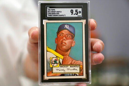 FILE - A Mickey Mantle baseball card is displayed at Heritage Auctions in Dallas, on July 21, 2022. A mint condition Mickey Mantle baseball card has sold for $12.6 million, blasting into the record books Sunday Aug. 28, 2022 as the most expensive ever paid for a piece of sports memorabilia. (AP Photo/LM Otero, File)    PHOTO CREDIT: LM Otero