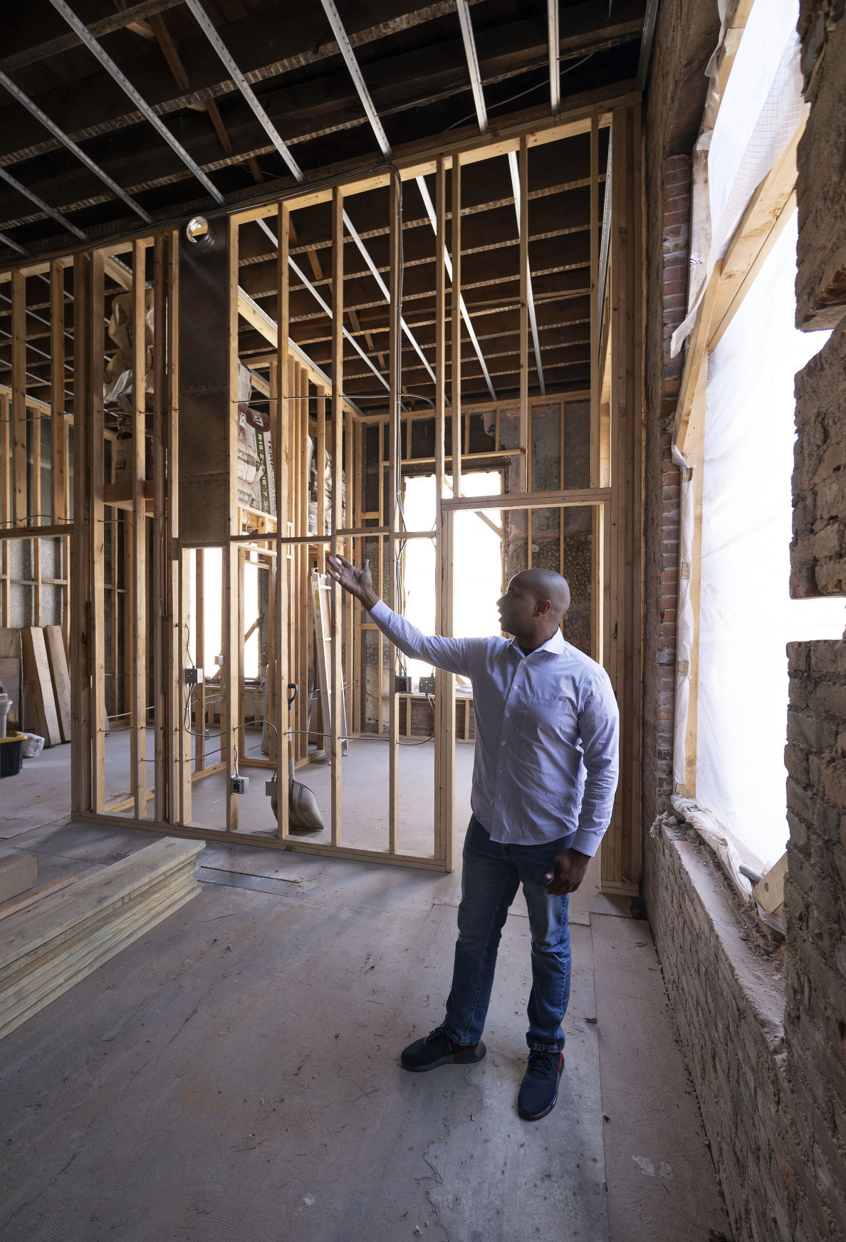 Developer Lloyd Singletary shows the construction inside the former Prescott School building in Dubuque on Tuesday.    PHOTO CREDIT: Stephen Gassman