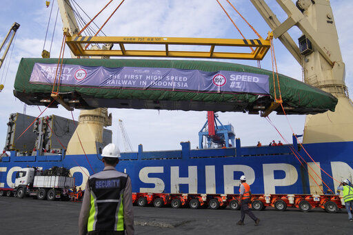 Workers unload a part of Chinese-made high-speed passenger train from a cargo ship at Tanjung Priok Port in Jakarta, Indonesia, today.    PHOTO CREDIT: Dita Alangkara