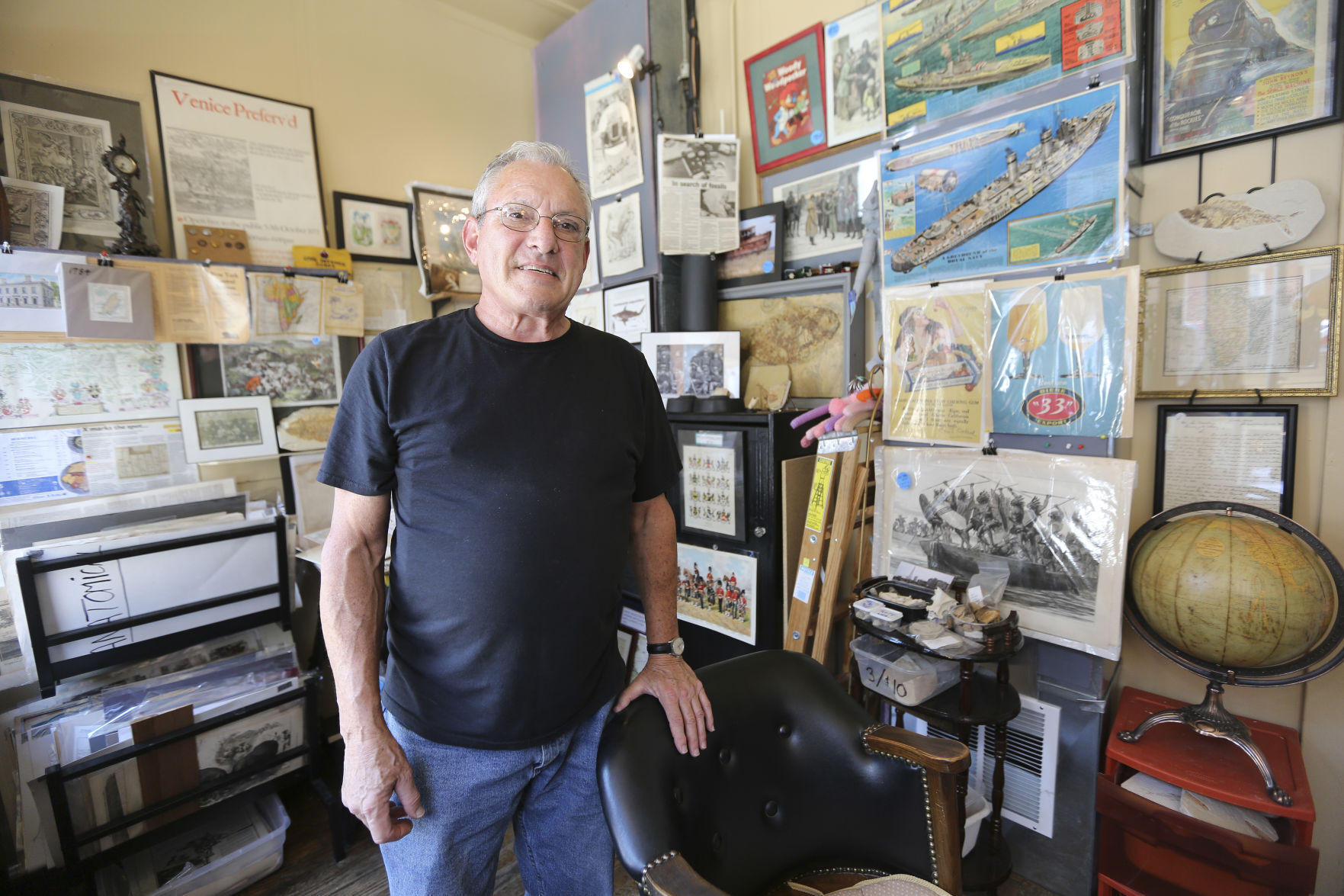 Owner Rick Pariser stands in Rix Antiques on Main Street in Galena, Ill., on Friday, Sept. 2, 2022. Pariser sells fossils, as well as antique maps and prints, that he has collected over the past two decades.    PHOTO CREDIT: Dave Kettering