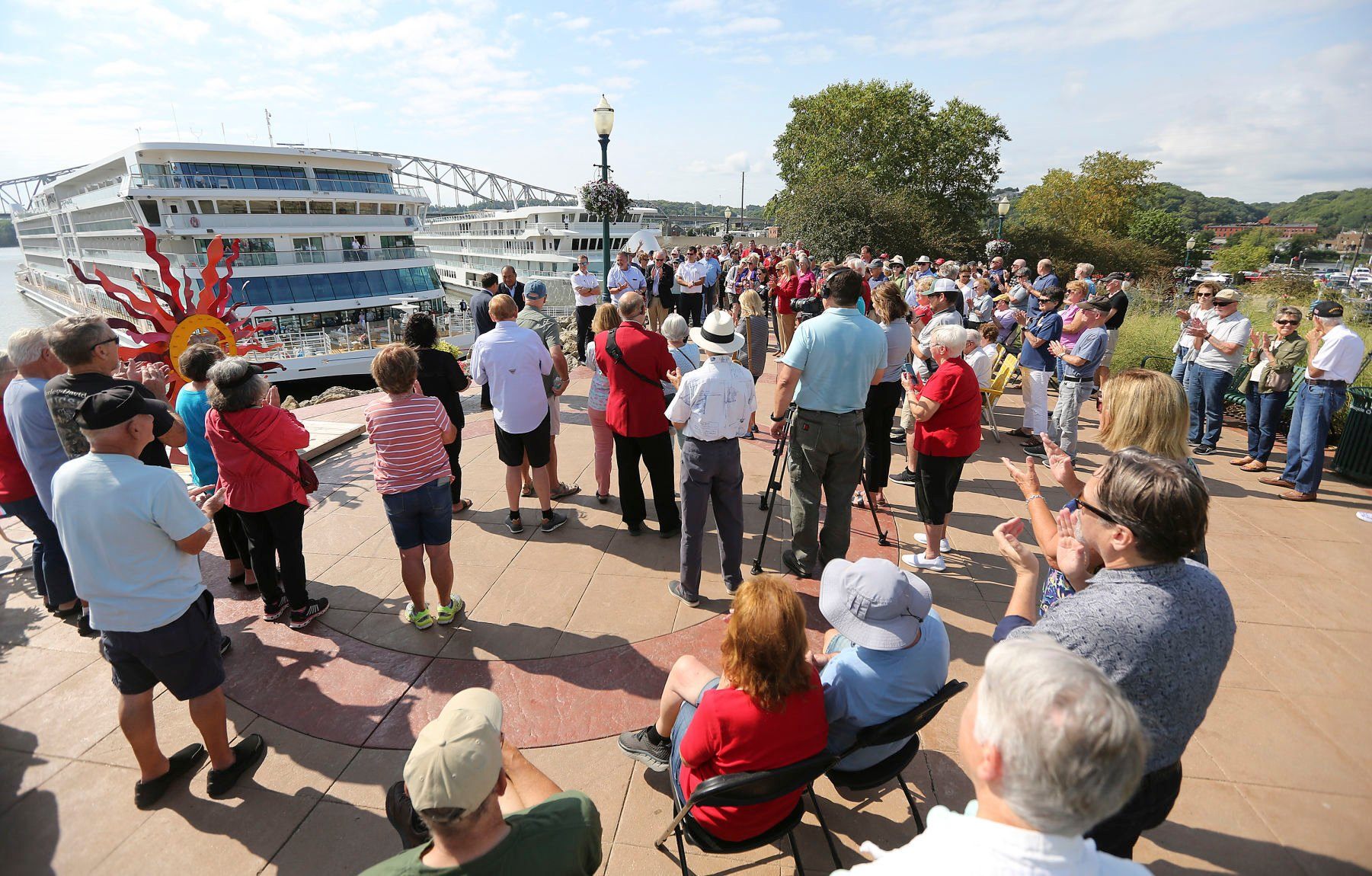 People gather at the Port of Dubuque for a ribbon-cutting for the Viking Mississippi cruise ship that docked for the first time on Tuesday, Sept. 6, 2022.    PHOTO CREDIT: Dave Kettering